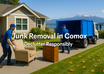 Junk removal professionals loading furniture into a truck outside a Comox home with ocean and mountains in the background.