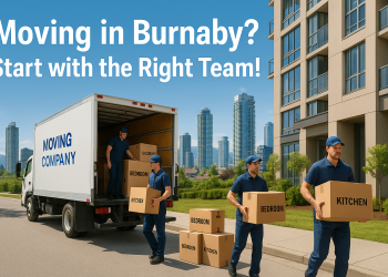 Movers unloading boxes from a truck outside a Metrotown high-rise in Burnaby, BC with skyline and mountains in background.