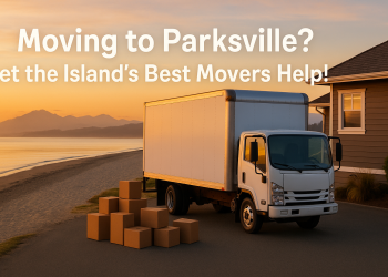A professional moving truck parked near a beachside home in Parksville, BC, with mountains in the distance and boxes being unloaded.