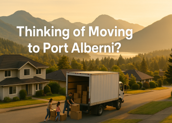 A moving truck in Port Alberni’s residential area with mountains and forests surrounding it at sunrise.