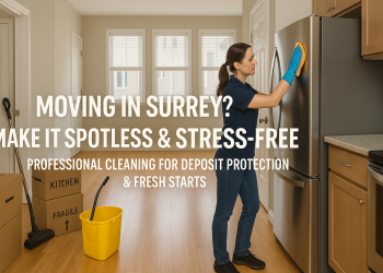 A clean and empty townhouse in Surrey, BC, with labeled moving boxes and a professional cleaner wiping down appliances, ready for new occupants.