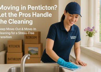 Professional cleaner wiping a countertop in a sunny Penticton home, moving boxes stacked neatly in the background.